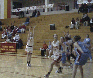Krista #34 scores over the Viking Defense